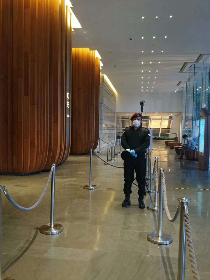 Nepalese guard duty in a high-class commercial tower